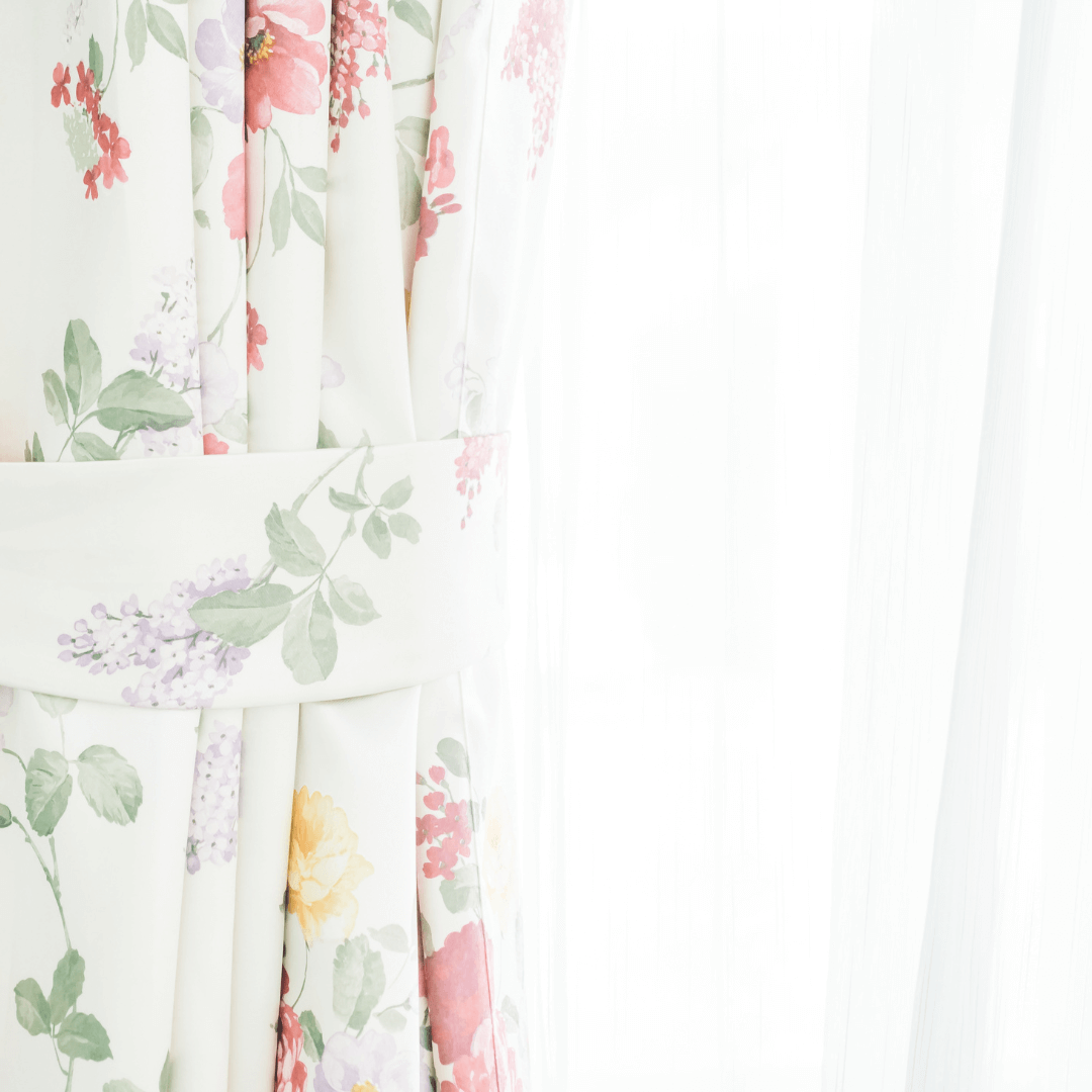 Floral curtains with light through a window