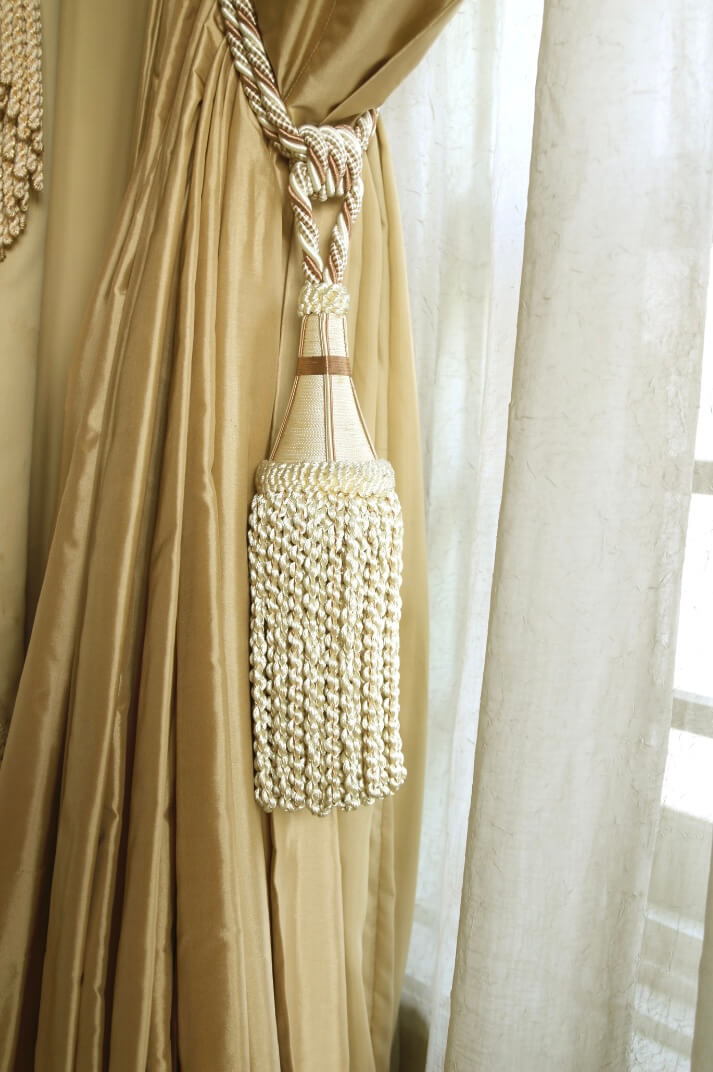 Elegant curtains in gold with tassels